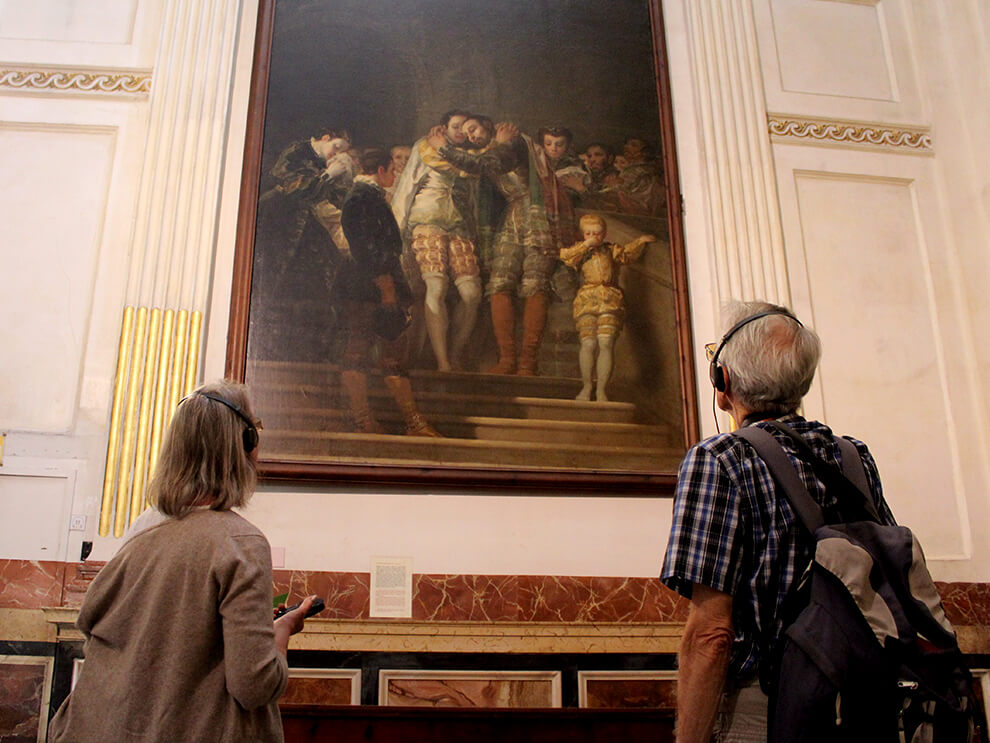 Visitors admiring a Goya painting in the chapel of San Francisco de Borja